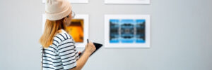 young woman at an art gallery writing notes