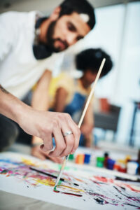 Man and woman painting in art studio