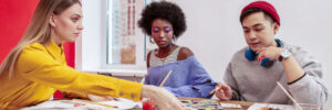 3 young adults at a group art class with Creative Ventures Gallery