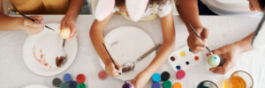 Family fun is all I want. a family painting Easter eggs together