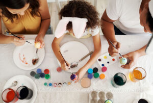 Family fun is all I want. a family painting Easter eggs together