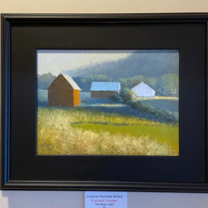 Magic Hour" by Elizabeth Craumer is a framed painting of three barns in a grassy field with hills under a hazy sky.