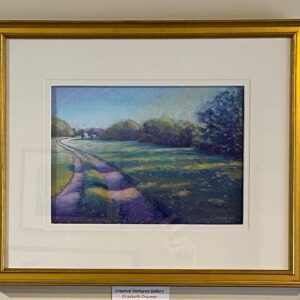 Summer Glow" by Elizabeth Craumer: a framed landscape of a winding path in green fields beneath a blue sky, wall-mounted.
