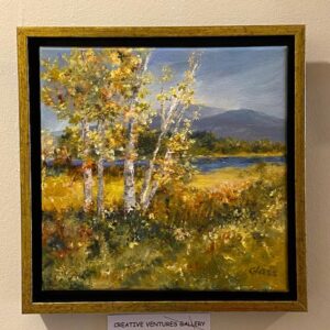 “Monadnock Autumn” by Betty Glass: framed painting of birch trees in a sunlit field with river and mountains.