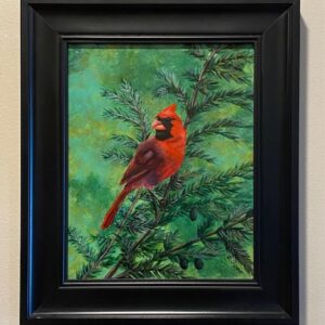 Summer Cardinal" by Brenda Ferro features a red cardinal on pine, framed in black and set against a beige wall.