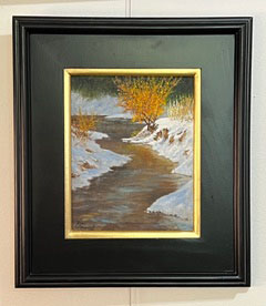 Winter Stream" by James O'Donnell: Framed painting of a snowy creek with yellow bushes and a dark green backdrop.