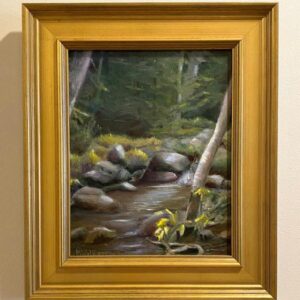 Movin' On" by Martha Wilkerson: a framed painting of a forest stream with rocks, trees, and yellow flowers.