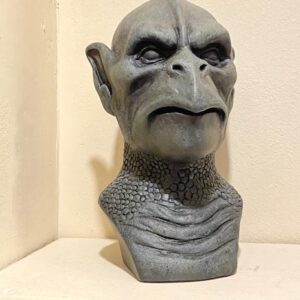 Gargoyle" by Paul Ducret: a gray, sculpted fantasy bust with pointed ears and a stern look on a white shelf.